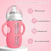 Pink silicone baby bottle with handles, clear nipple cover, and visible measuring scale